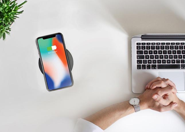 Desk with laptop image and phone charging